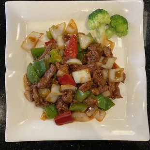 beef and vegetables on a white plate