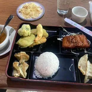Bento Box w Teriyaki Salmon, Egg Drop soup, tempura veggies, crab Rangoon, fried wonton, egg roll, white rice.