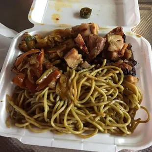 a plate of noodles and meat