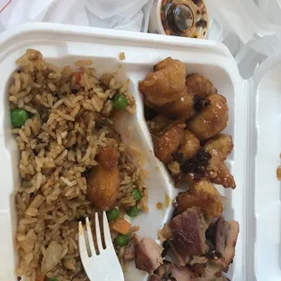 a plate of rice, meat and vegetables