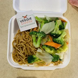a container of noodles and broccoli