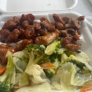 a takeout container with meat and vegetables