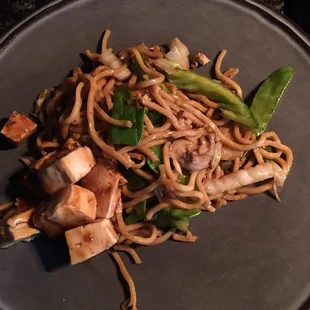a plate of noodles and tofu