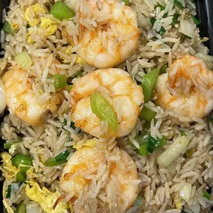 shrimp and rice in a black bowl
