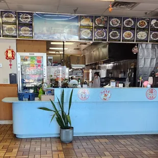 a restaurant counter with a potted plant