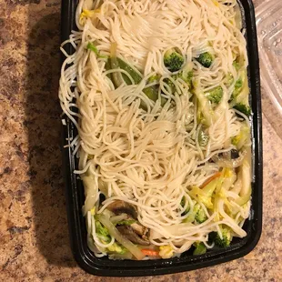 noodles and vegetables in a plastic container