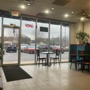 the inside of a restaurant with tables and chairs