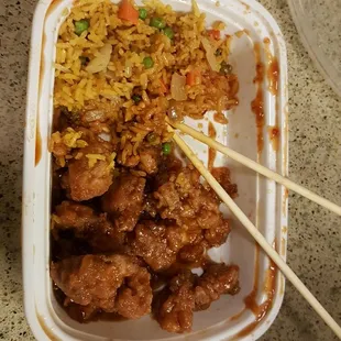 a container of food with chopsticks