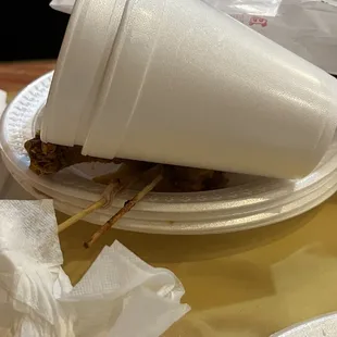 a paper cup with a stick sticking out of it