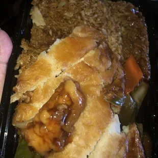 a hand holding a container of food