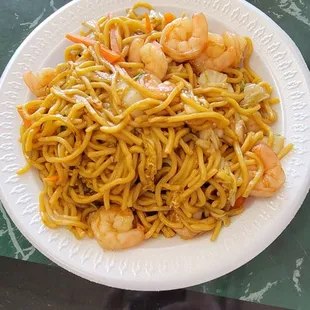 a plate of noodles and shrimp