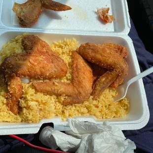 Chicken wings with fried rice.