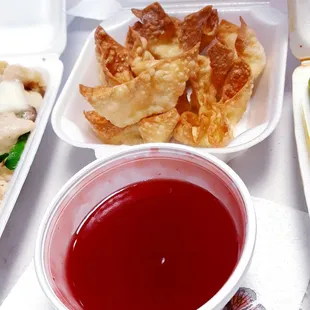 a tray of food and a bowl of sauce