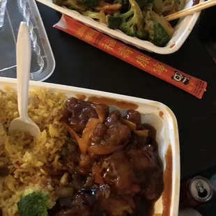 two takeout containers of food on a table