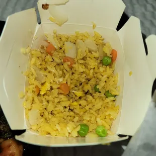 a takeout box with rice and vegetables