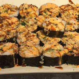 a plate of sushi with sauce