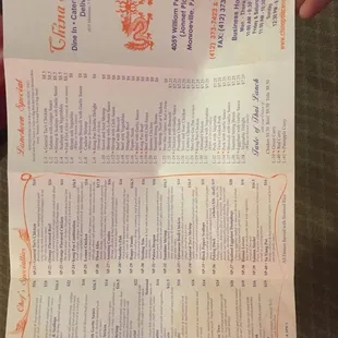 a person holding up a menu