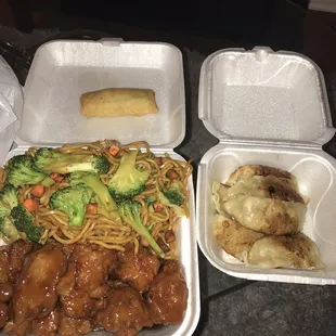 two take out containers of food on a table
