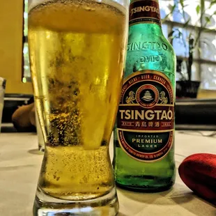 a glass of beer and a hot dog