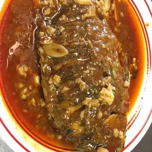 a bowl of steamed fish with sauce