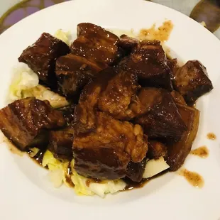 a plate of food with meat and cabbage