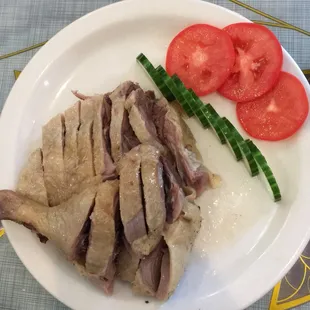 a plate of sliced meat and vegetables
