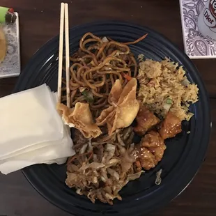 a plate of food with chopsticks