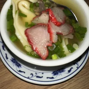 a bowl of soup with meat and noodles