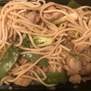 noodles and meat in a black container