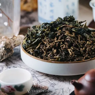 a bowl of tea and teapots