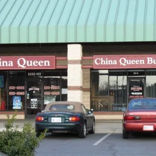 two cars parked in front of a chinese restaurant