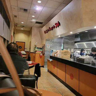 people sitting at tables in a restaurant