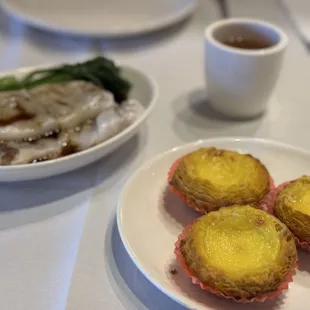 Egg tarts, steamed rice noodles, and oolong tea