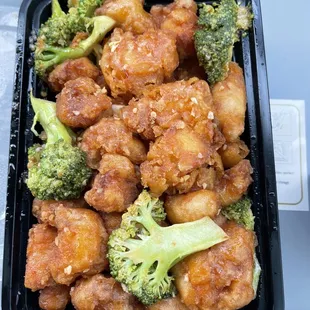 a tray of chicken and broccoli