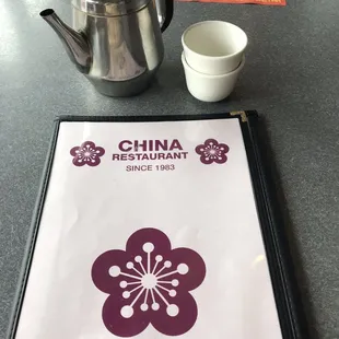 a menu and a teapot