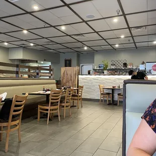 a woman sitting at a table in a restaurant