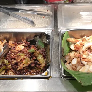 two trays of food on a table