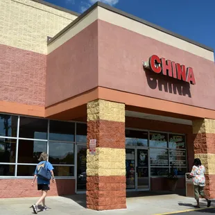 people walking in front of a chinese restaurant