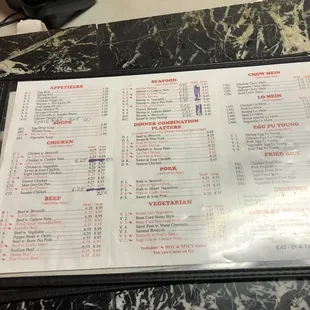 a menu on a marble table