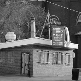 a man standing in front of a chinese restaurant