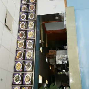 a restaurant entrance with colorful plates on the wall