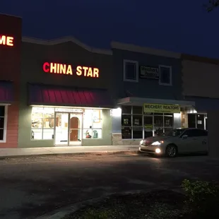 Store front with a line of cars parked in the fire lanes all the time