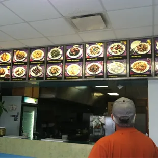 a man standing in front of a menu