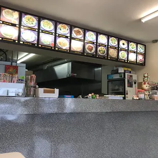 the counter and menus of a chinese restaurant