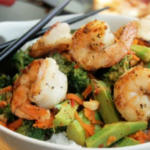 shrimp and broccoli in a bowl with chopsticks