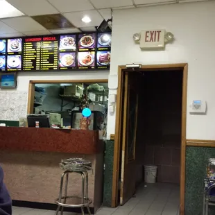a man standing in front of a restaurant counter