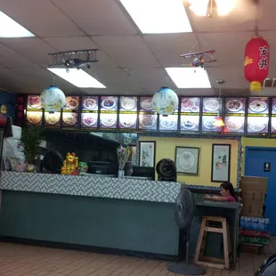 a restaurant counter with a lot of asian food