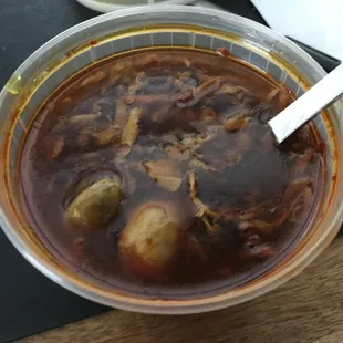 a bowl of soup with a spoon in it