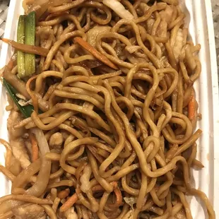 a plate of noodles with meat and vegetables
