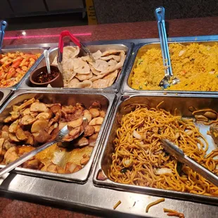 a variety of food in a buffet
